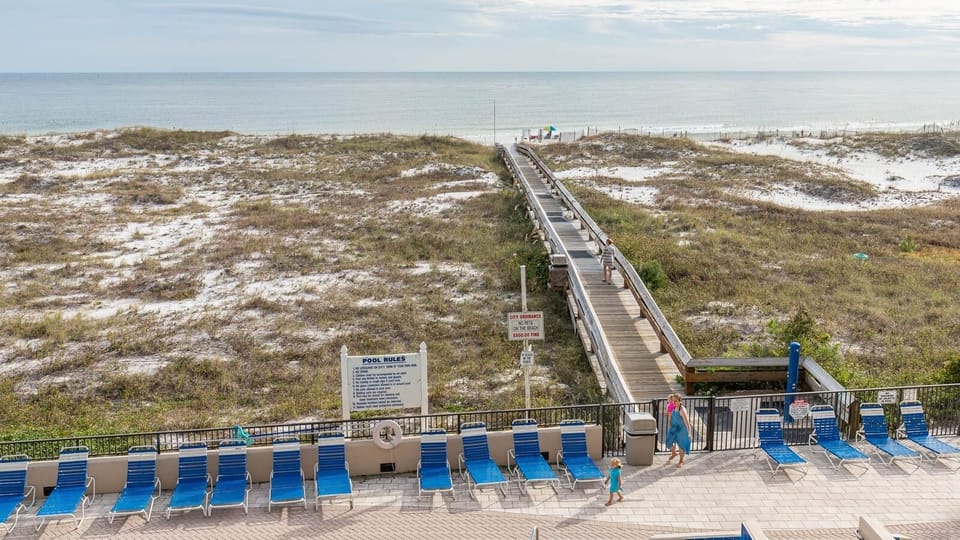 Relax by the poolside on lounge chairs, with a boardwalk leading you to the beach just steps away