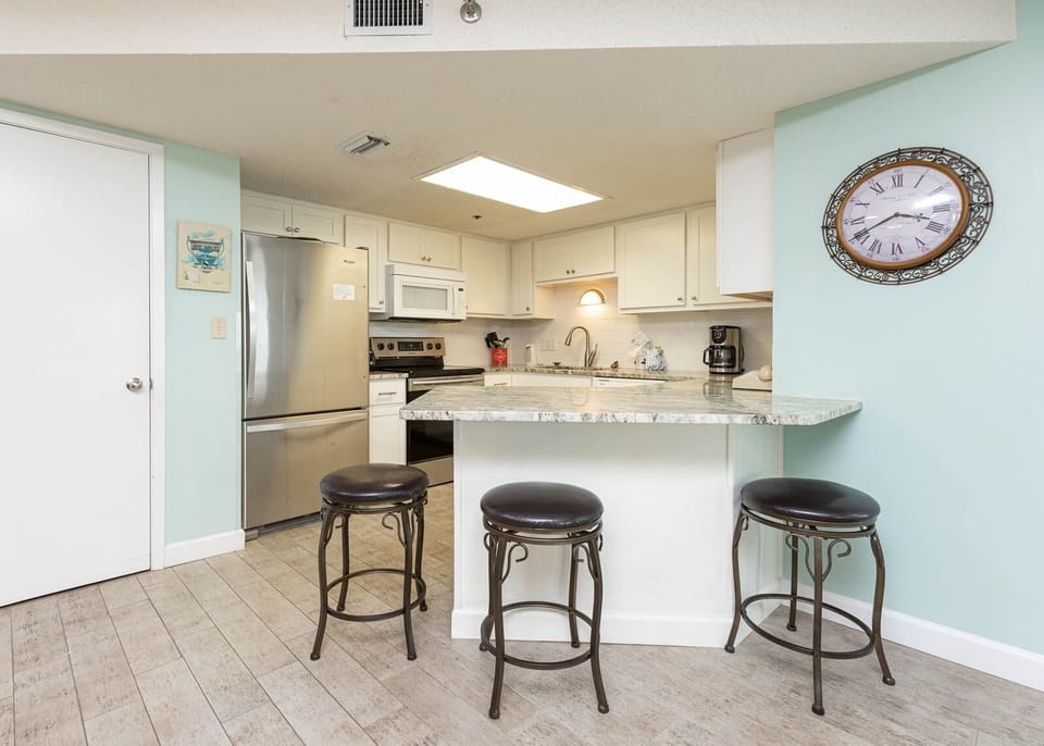 Gather around the stylish kitchen bar with seating, perfect for casual meals and morning coffee