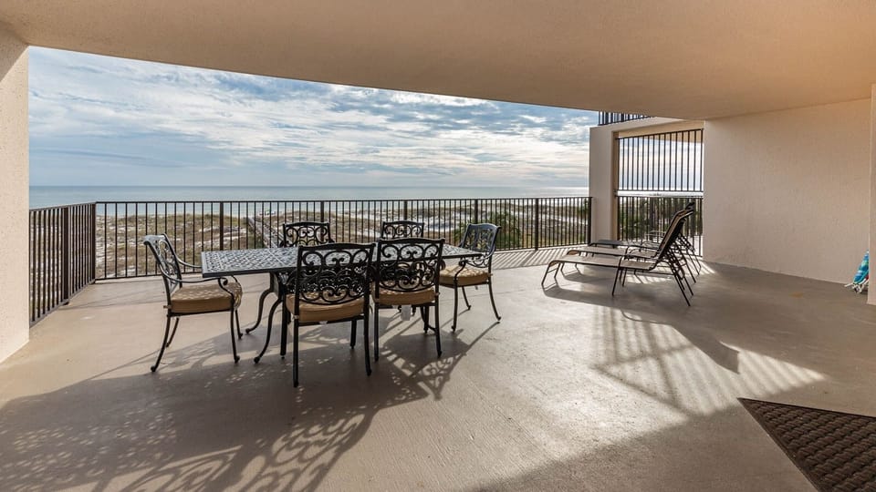 Relax on the spacious beachfront balcony, perfect for meals or sunbathing with a view of the tranquil waters