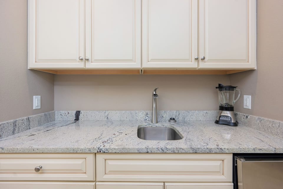 Blend your favorite smoothies at the attractive wet bar, combining convenience with style in your cozy getaway