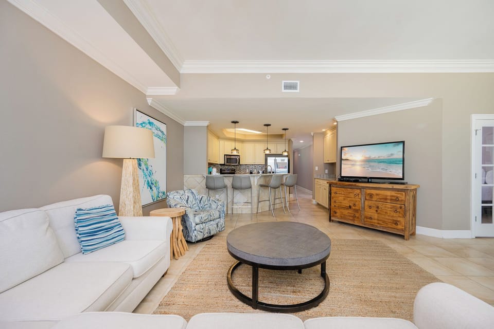 Relax in the inviting living area, where plush seating and a large TV make family movie nights a delight