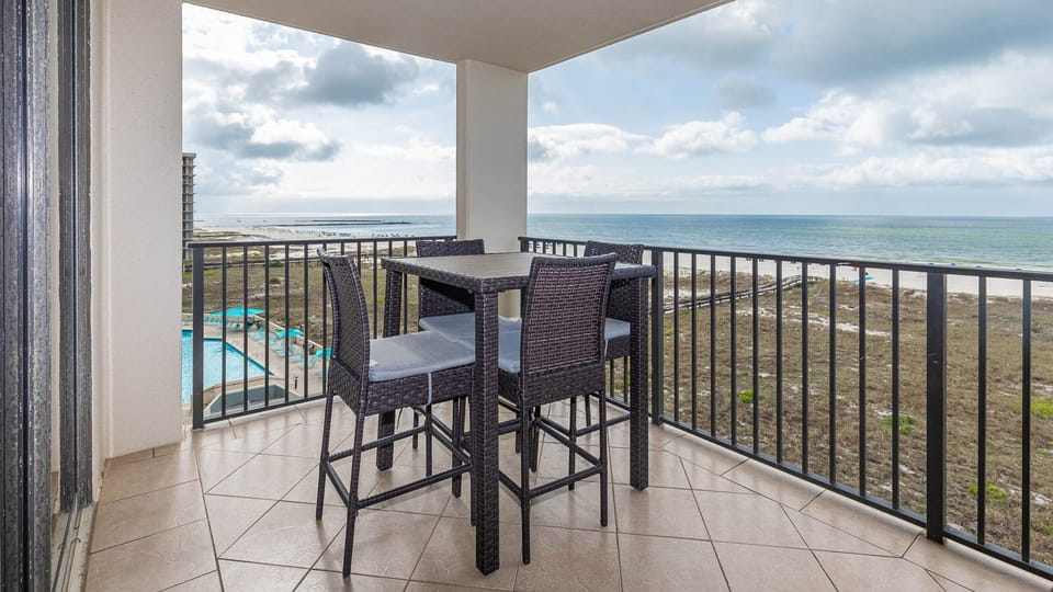 Balcony seating offers a perfect spot to enjoy views of the beach and tranquil waters, enhancing your vacation experience