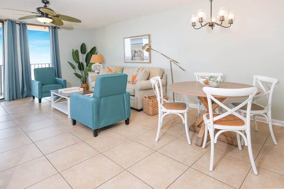 Relax in the bright living area with comfortable seating, a dining table, and views that invite you to unwind