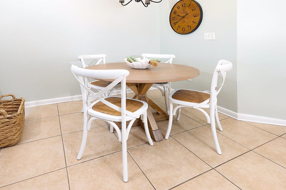Gather around the round dining table with stylish white chairs, perfect for meals or games during your stay