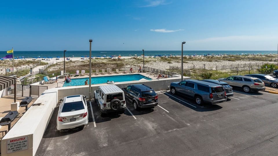 Enjoy a refreshing view of the pool and beach from this inviting balcony, perfect for relaxation and fun