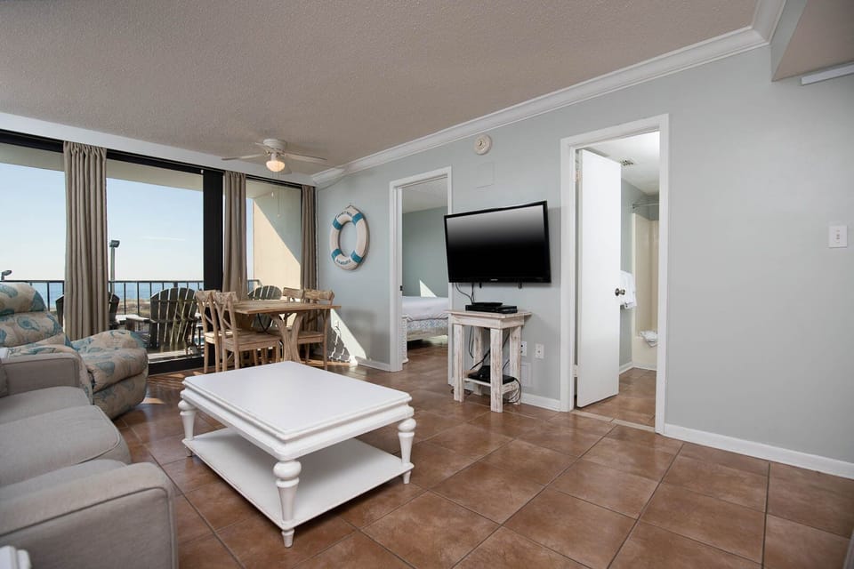 This inviting living area features a comfortable seating arrangement and a dining space with a stunning beachfront view