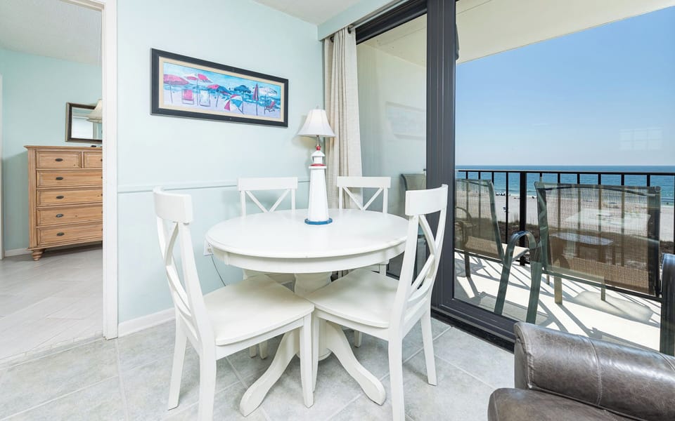 Gather around the round table for laughter and games while enjoying beach views through the wide glass door