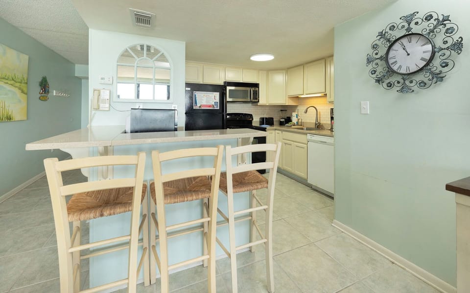 Sip your morning coffee at the high-top counter while enjoying the cozy kitchen vibe and its inviting design