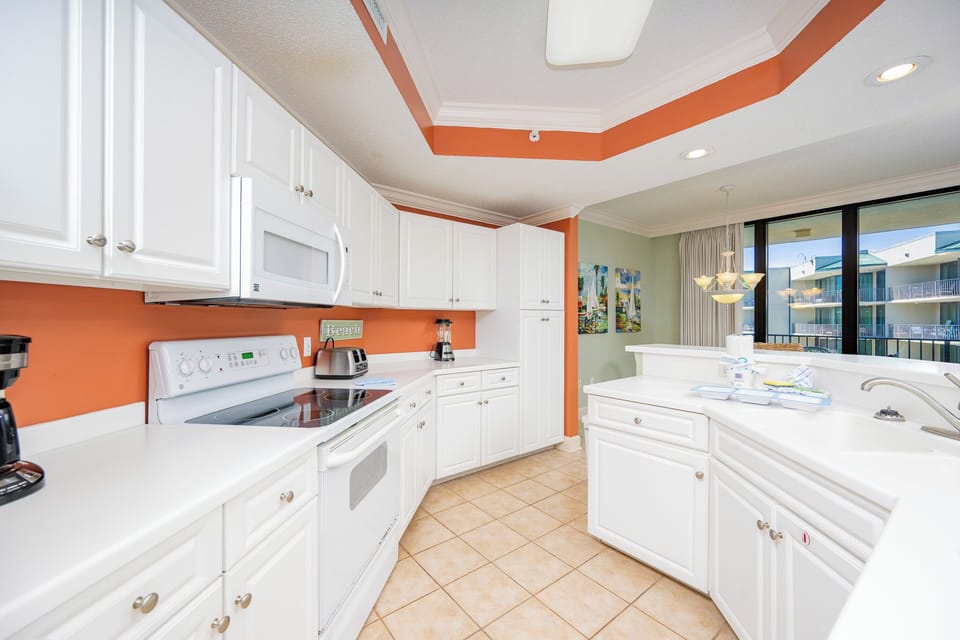 Experience the joy of preparing your favorite meals in this cheerful kitchen, with plenty of counter space and views