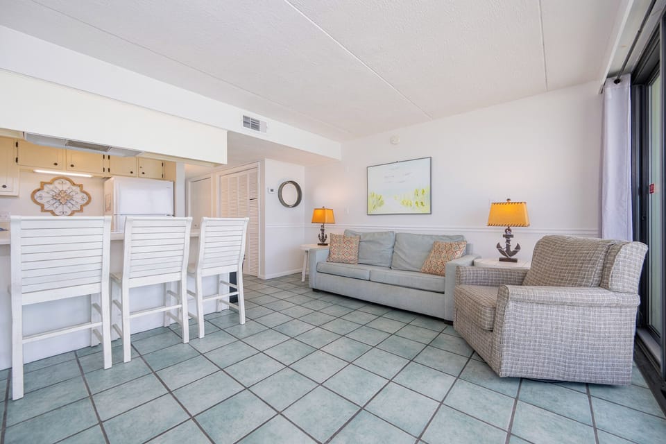 Unwind in the cozy living area, basking in gentle natural light and savoring conversation with loved ones