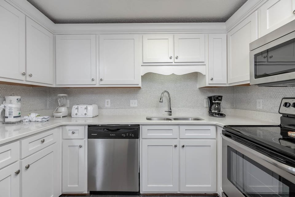 Cook and gather in the bright kitchen featuring sleek countertops and stainless steel appliances for your culinary delights
