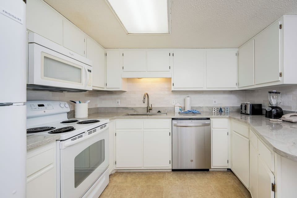 Warm light above the sink brightens the kitchen as you prepare fresh meals for your family to enjoy