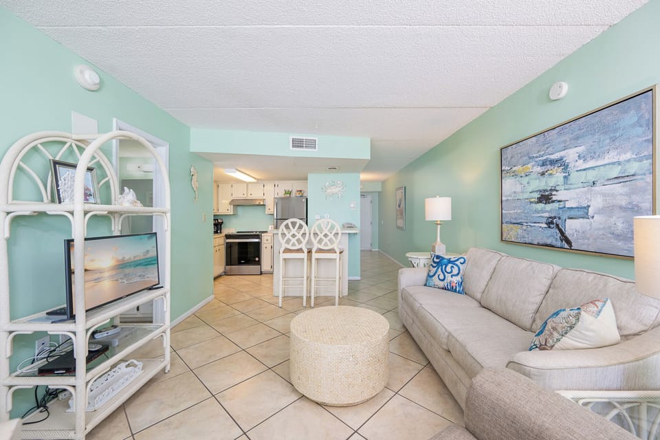 Relax on the sofa with a queen sleeper while enjoying family time and the inviting coastal vibe around you