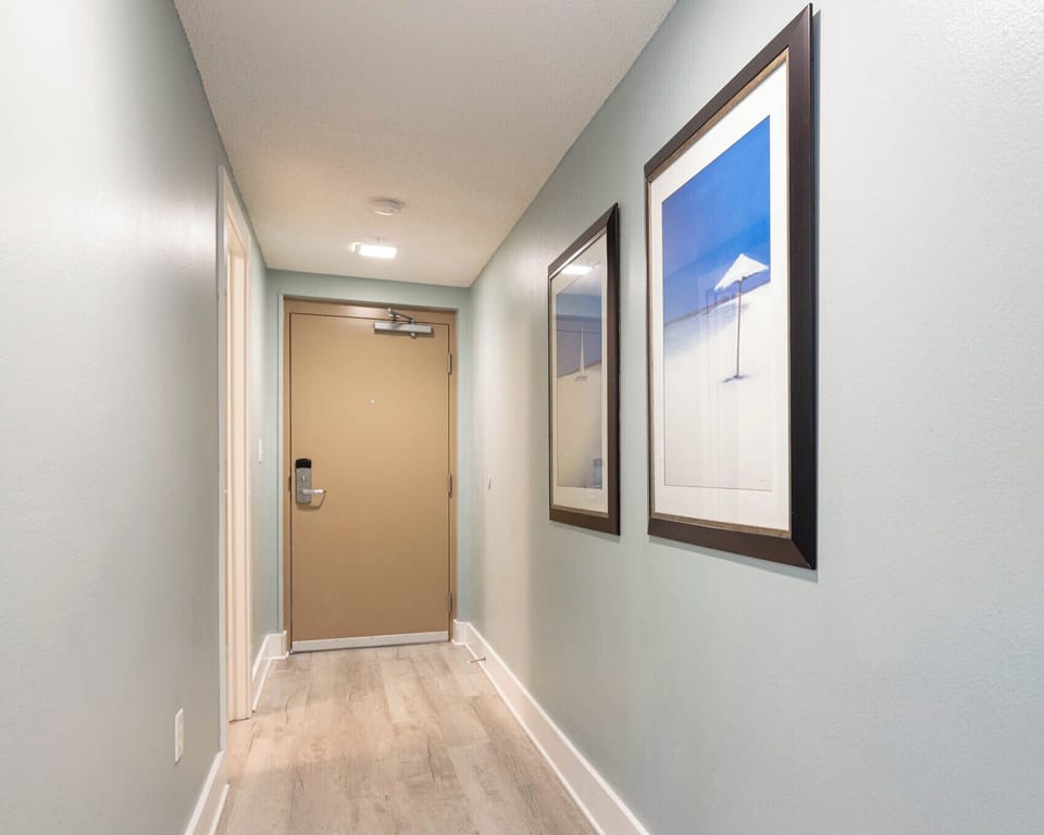 Welcoming entryway with coastal decor a light flooring, inviting guests to enjoy this beachfront vacation rental