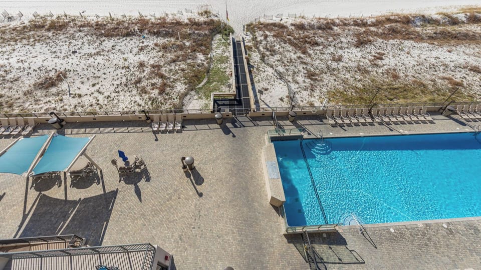 Inviting pool area, enjoying comfortable seating and easy access to the beach just steps away
