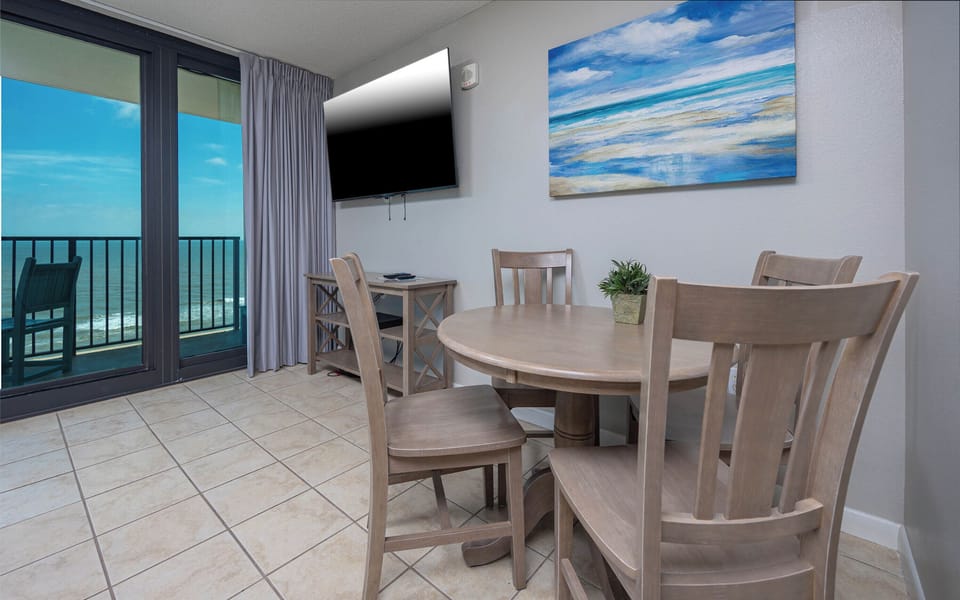 Enjoy meals or games at the round dining table while taking in the beach view from the balcony