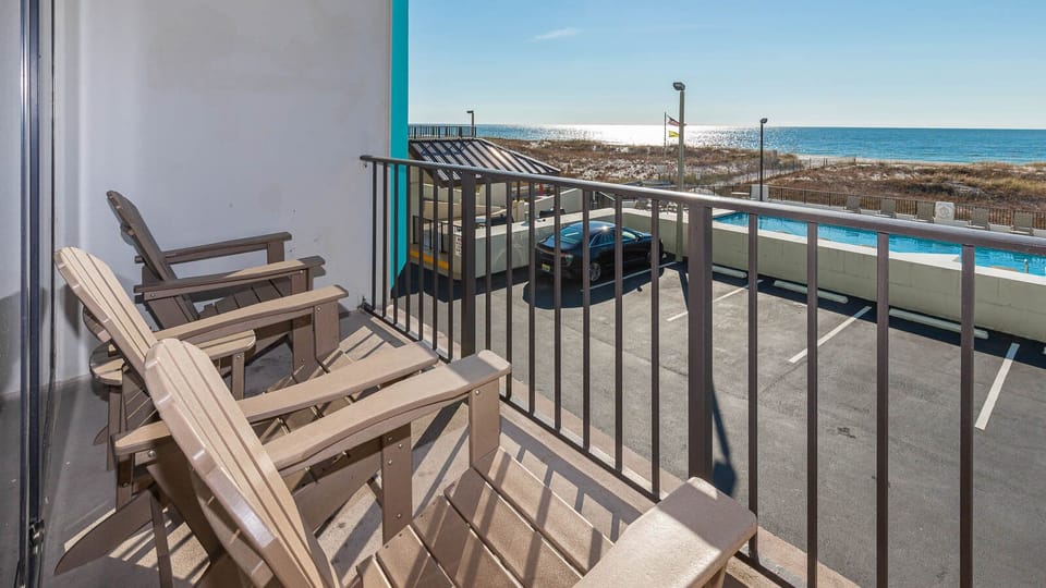 Relax on the balcony with comfortable seating and enjoy stunning beachfront views