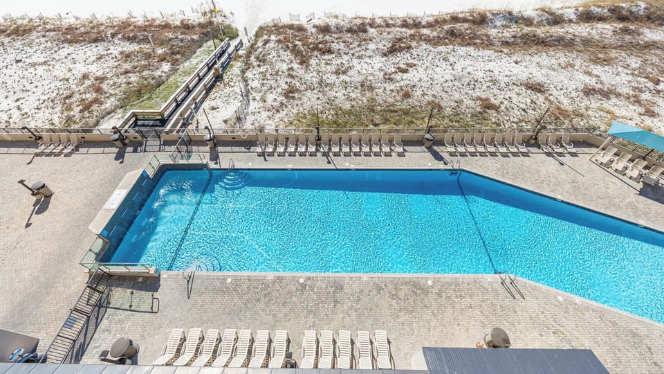 Take a refreshing dip in the inviting pool, surrounded by comfortable lounge chairs for relaxation under the sun