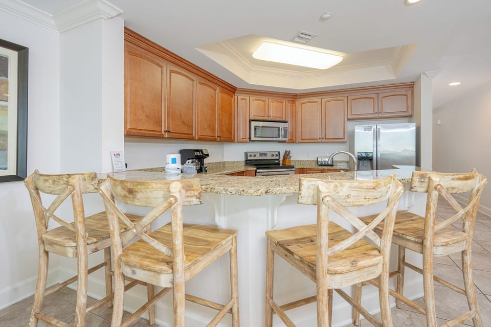 Bask in the warmth of your kitchen as you create memorable family snacks while seated at the inviting breakfast bar