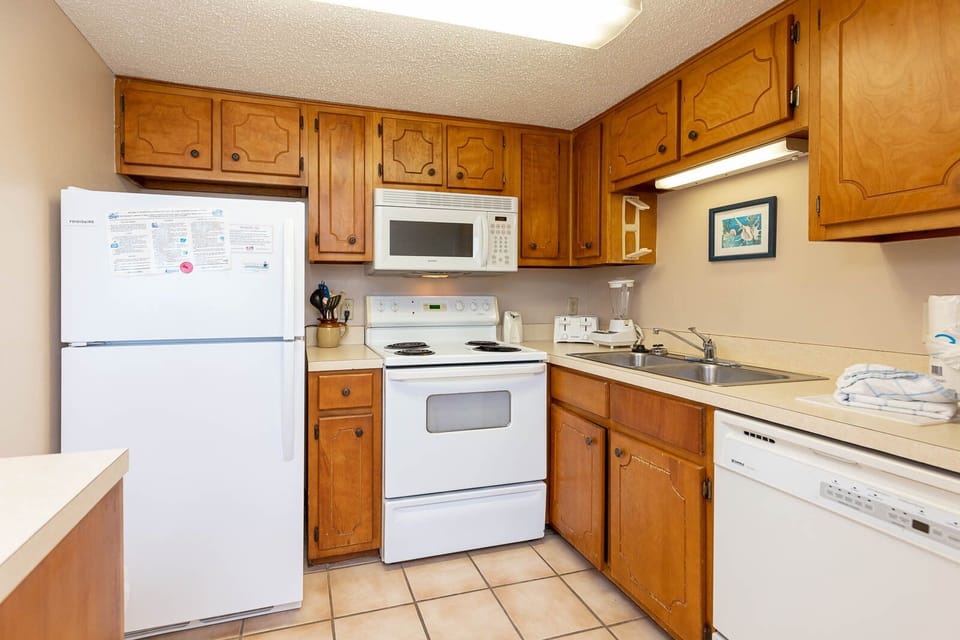 This kitchen features wooden cabinetry and a welcoming atmosphere for preparing meals during your stay
