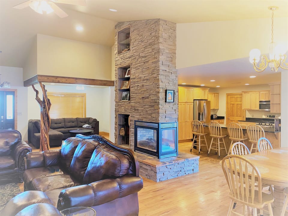 Spacious Open Floor Plan with Kitchen and Two Living Areas and Fireplace
