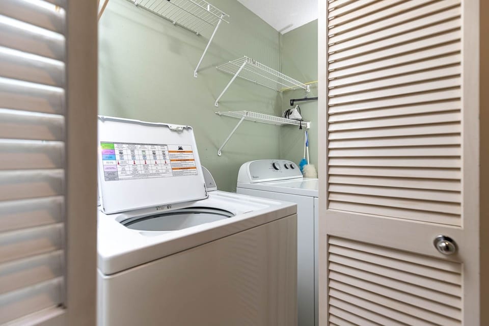 Utilize the laundry area with convenient appliances and shelving for a hassle-free stay during your vacation