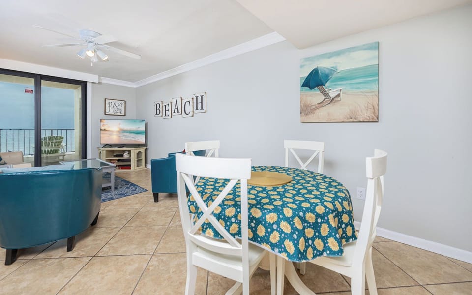 Gather around the cheerful table, where laughter and shared stories fill the air as you unwind in your beachside retreat