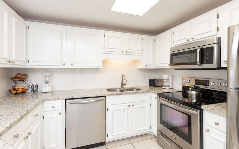 Stainless appliances and granite countertops in this inviting kitchen, featuring a blender and coffee maker