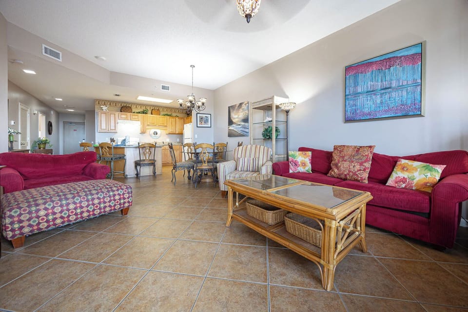 Relax in the spacious living area, featuring colorful seating and a dining table for shared meals and laughter