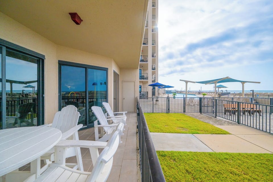 Ground floor patio with plenty of seating for enjoying time with family on your next beach adventure