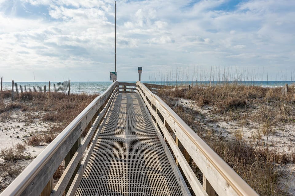 Enjoy the private wooden boardwalk to the sandy beach, where relaxation and coastal views await you