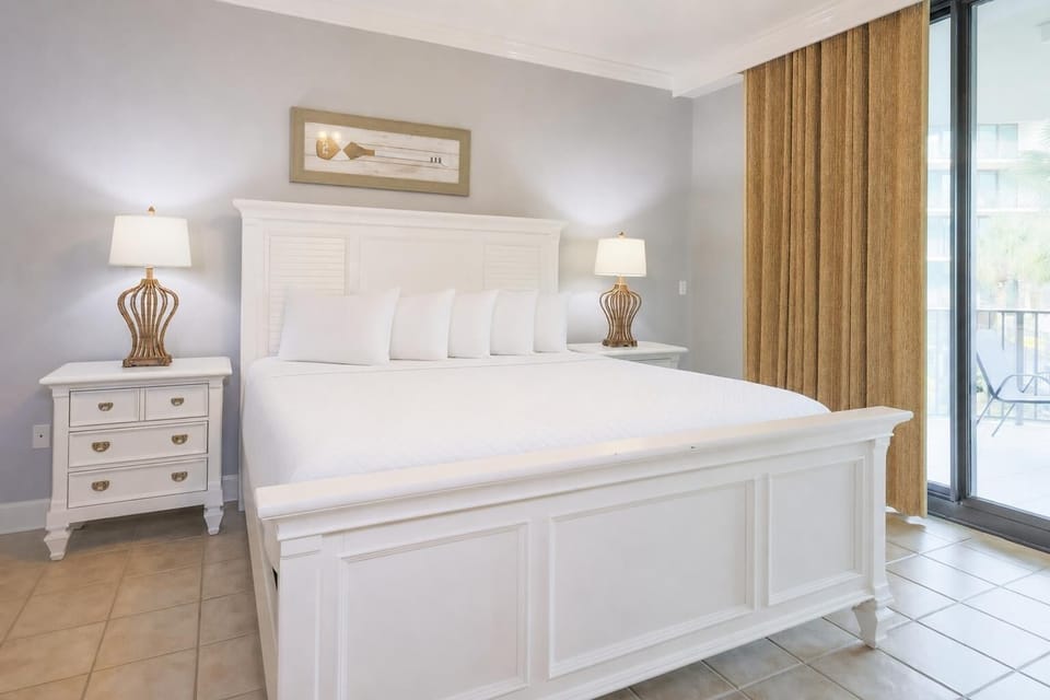 Retreat to the king master suite with cozy bedding and drift off to coastal sights and sounds of the bay