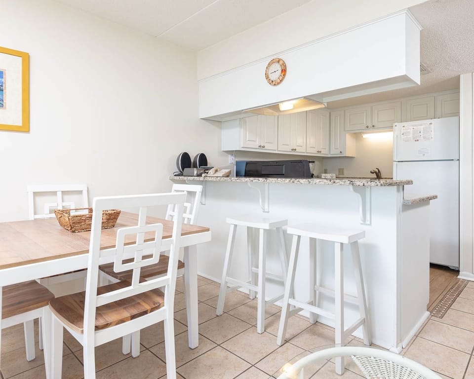 This inviting kitchen features a breakfast bar, modern appliances, and a cozy dining area for memorable meals together