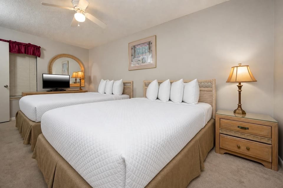 Inviting guest bedroom featuring two comfortable queen beds and a TV