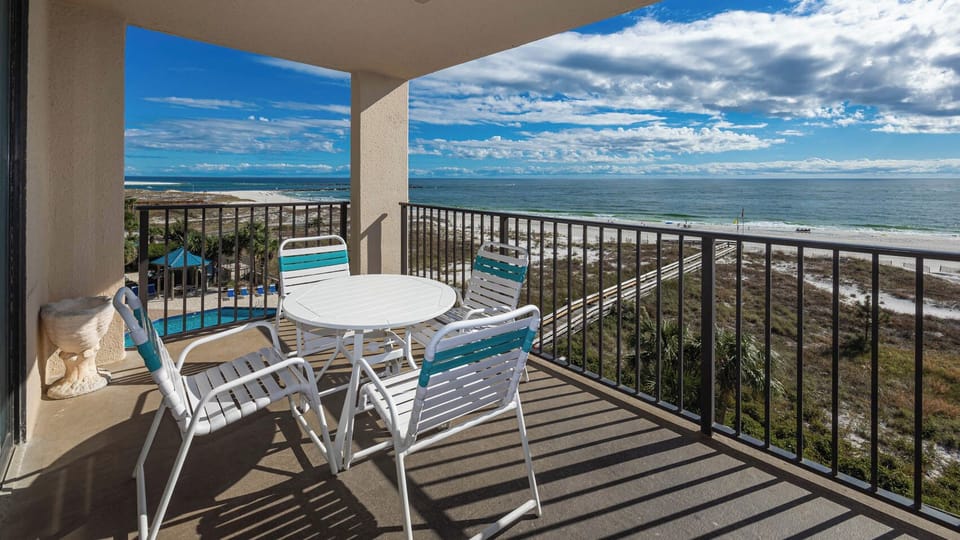 Relax on the balcony enjoying the calming views of the waves and beach