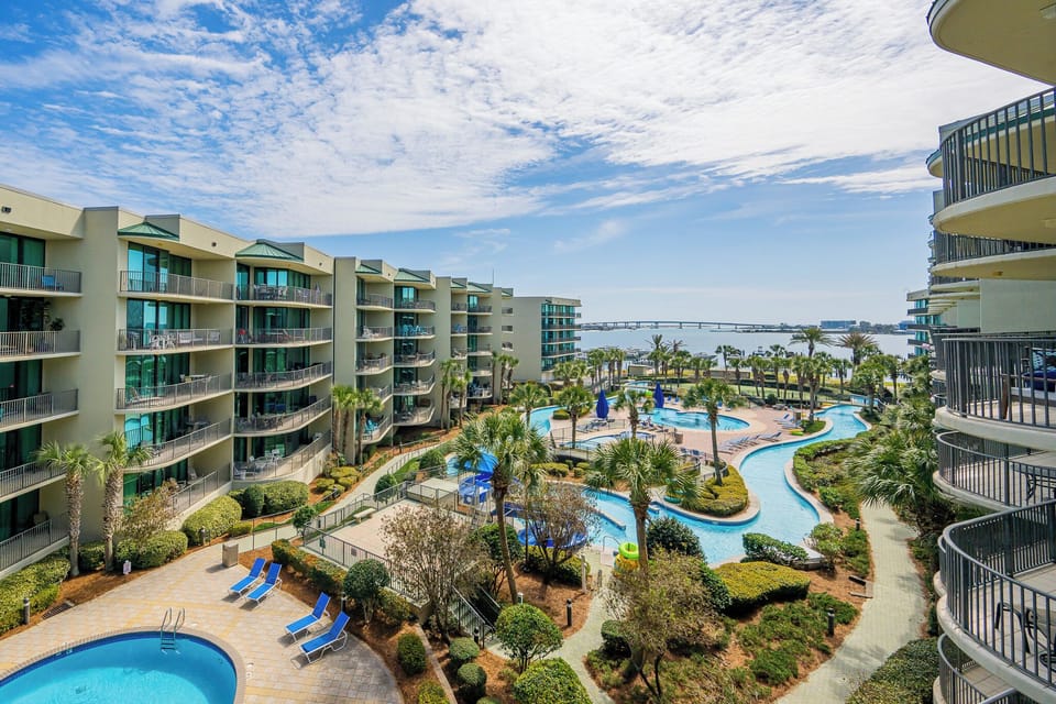 Relax on the balcony, savoring gentle breezes and tranquil views over lush landscaping and the inviting bay