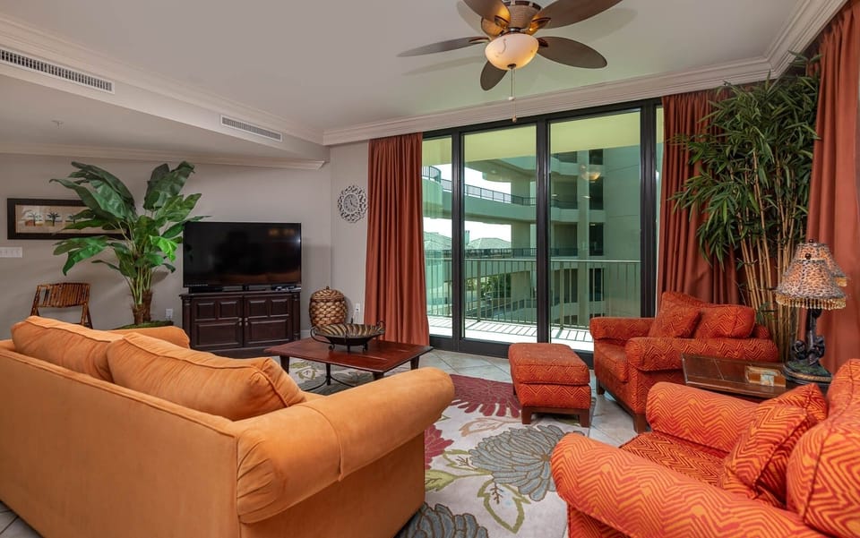 Relax in the spacious living room, surrounded by soft textures and vibrant decor, featuring a queen sofa sleeper