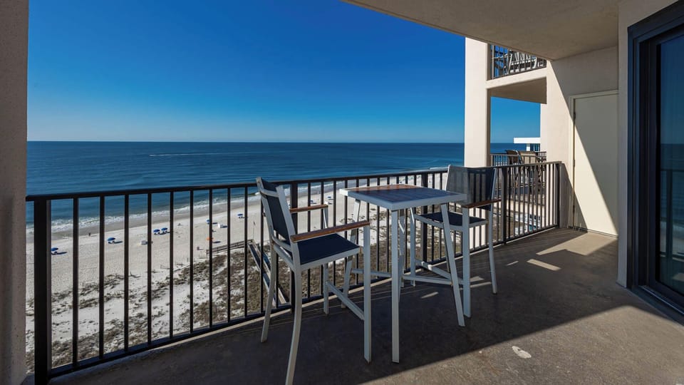 Fresh gulf air and scenic views from the balcony with seating, perfect for relaxing or dining outdoors