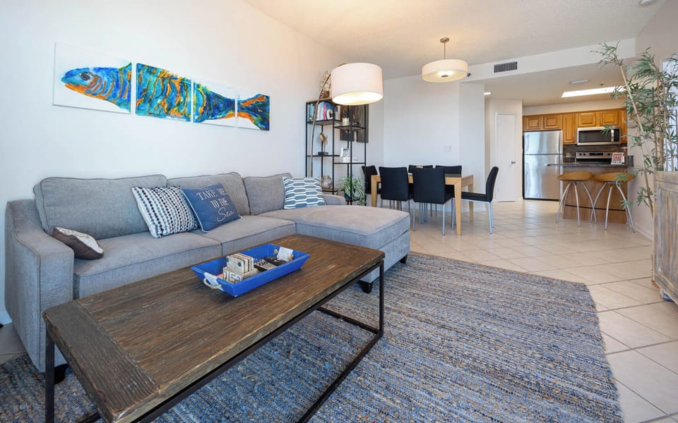 Relax in the spacious living area with comfortable seating, vibrant decor, and a dining table for shared meals