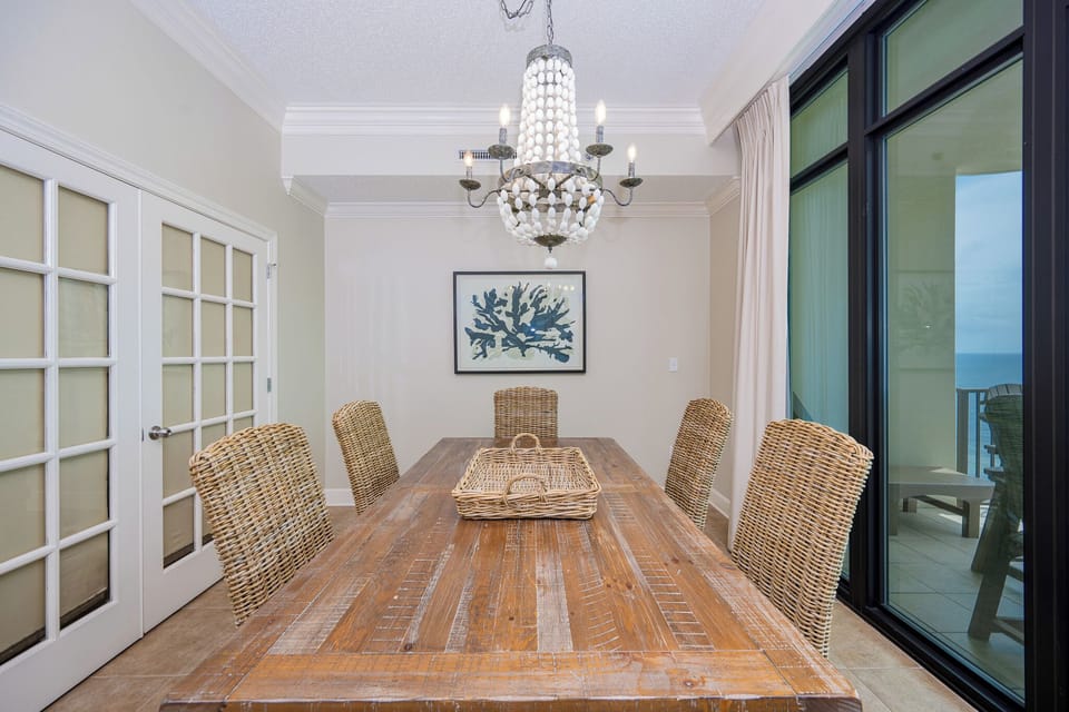 Gather around the rustic table with loved ones, sharing stories while basking in the inviting coastal vibe