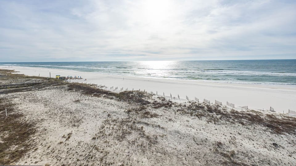 Gaze at the serene waters and soft shoreline, perfect for beach walks and relaxation under the sun