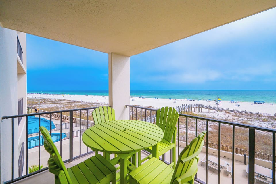 Bright green chairs invite you to sip morning coffee while watching waves roll along the gulf coast