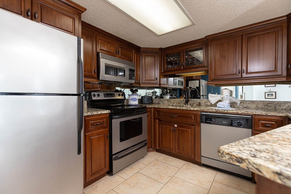 Cook and gather in this inviting kitchen, featuring granite countertops and stainless appliances