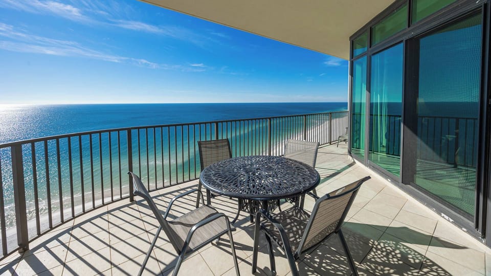 Relax at the table on your balcony, soaking in stunning views and the refreshing vibe of the coast