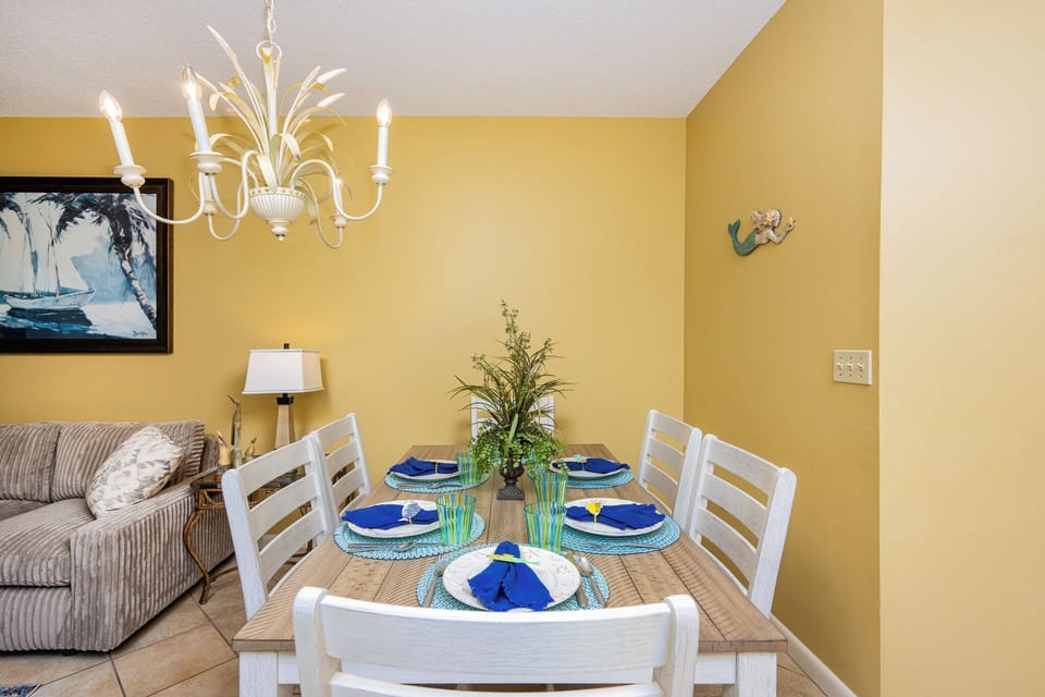 Gather around the dining table adorned with vibrant plates and a charming centerpiece, perfect for memorable meals