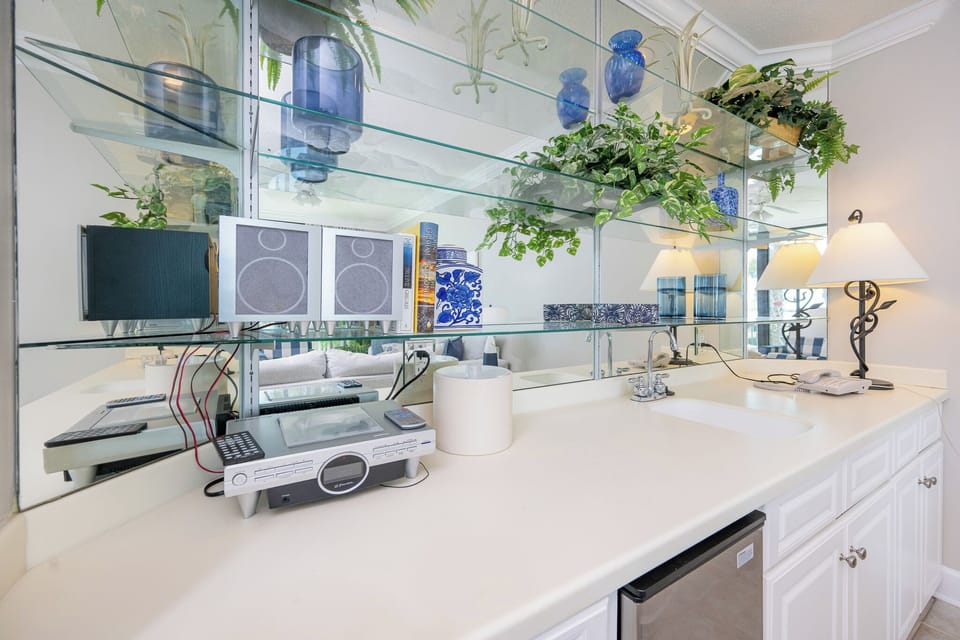 Mix up refreshing beverages at the sleek wet bar while enjoying views of the lively living area