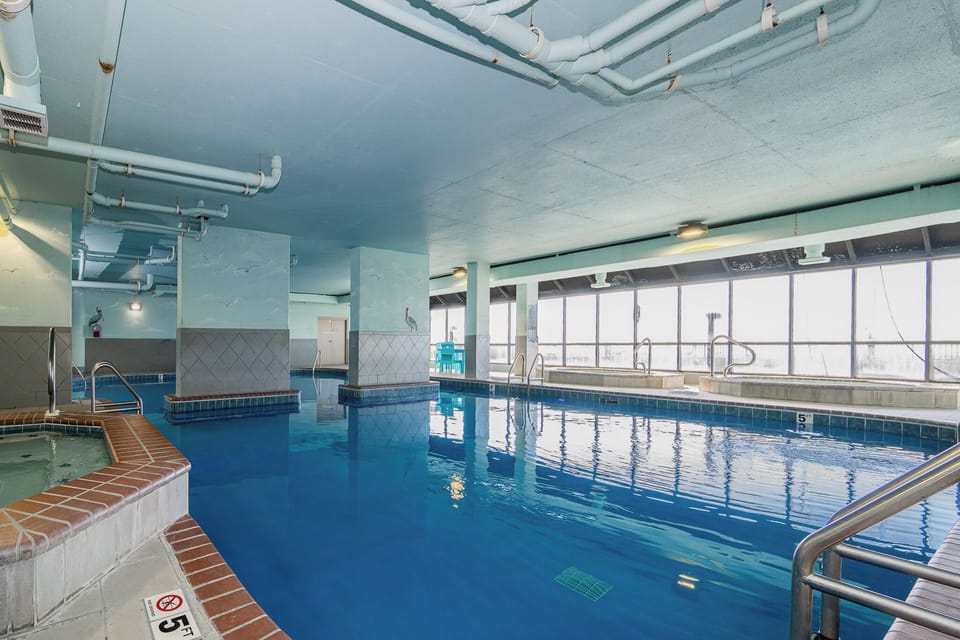 Dip into relaxation at the indoor pool at Phoenix X, complete with hot tubs and stunning views for a refreshing beach getaway