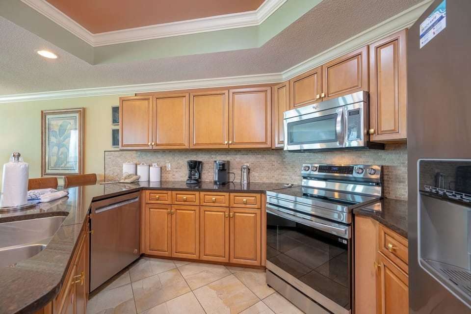 Gather around the kitchen island with bar stools, enjoying the warm wood tones and sleek stainless appliances for meal
