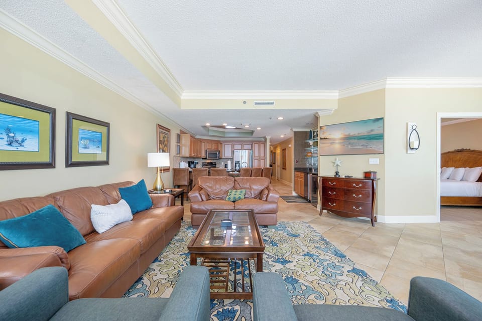 Relax on the leather sofas surrounded by vibrant decor, with a view of the open kitchen and dining area nearby