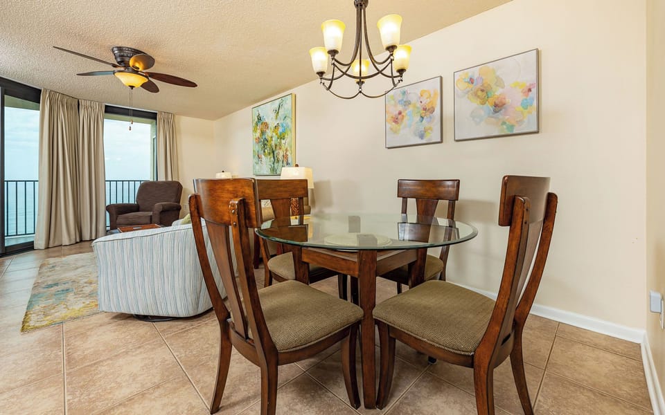 Sit around the glass table in the dining area while coastal breezes drift through the sliding doors nearby